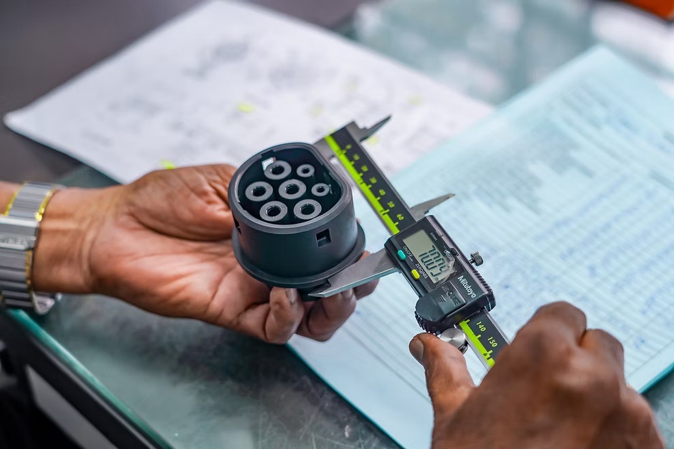 Quality inspection — measuring plastic component with Mitutoyo caliper